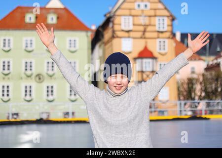 Glücklicher Junge, der tagsüber Schlittschuhlaufen und Spaß hat Stockfoto