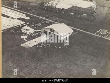 Flughafen Tjililitan in Batavia, aus der Luft gesehen, ca. 1930 - ca. 1940 Fotoalbum Magazin mit einem Foto der Gebäude und des Rasenplatzes des Flughafens Tjililitan, dem Endziel des KLM-Fluges Amsterdam-Batavia. Teil des Gedenkalbums der Indischen Linie von KLM, Teil I Batavia-Papier. Unterstützung für Fotos. Pappe Gelatine Silberdruck Luftverkehr, Luftfahrt. Reisen; Tourismus. Flugplatz, Flughafen Batavia Stockfoto