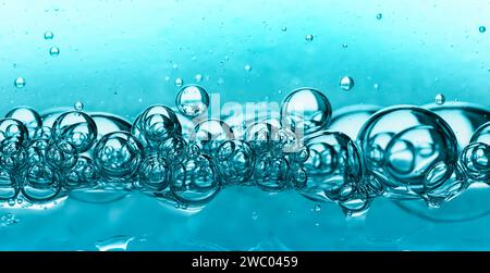 Abstrakter Hintergrund von Blasen, die in türkisfarbenem Gel schwimmen. Makrofotografie Stockfoto