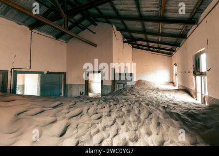 Wüstensand bedeckt das Innere eines der vielen verlassenen Grundstücke der alten Geisterstadt Kolmanskop im Süden Namibias Stockfoto