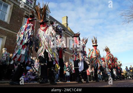 Morris-Tänzer treten auf, während der Strohbär während des Whittlesea Straw Bear Festival in Whittlesea, Cambridgeshire, durch die Straßen gleitet. Bilddatum: Samstag, 13. Januar 2024. Stockfoto