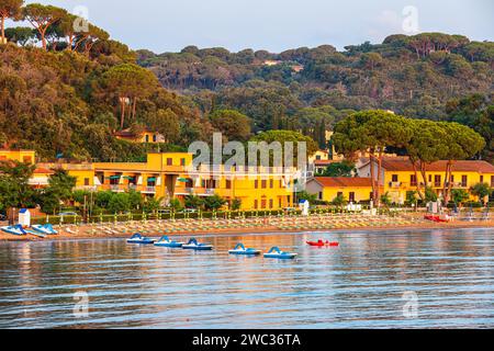 Tretboote, Liegestühle und Sonnenschirme am Strand von Naregno bei Sonnenaufgang, in der Nähe von Capoliveri, Elba, toskanischem Archipel, Toskana, Italien Stockfoto