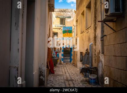 Ein Berber-Kunsthandwerk mit handgemalten Motiven am Ende einer engen Kopfsteinpflasterstraße in der alten Medina von Sousse in Tunesien. Stockfoto