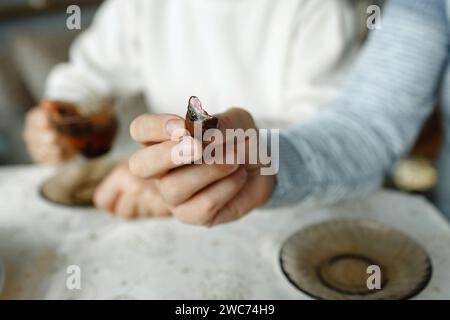 Ein Mann isst Schokoladenbonbons und hält sie in der Hand. Nahaufnahme. Stockfoto