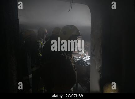 Noida, Indien. Januar 2024. NOIDA, INDIEN – 14. JANUAR: Ein Team von Feuerwehrleuten, die versuchen, ein Feuer zu löschen, entkernt in einem Haus und rettete drei Menschen in Sektor 25, am 14. Januar 2024 in Noida, Indien. Vier Fahrzeuge der Feuerwehr brachten den Brand nach etwa einer Stunde Einsatzzeit unter Kontrolle. (Foto: Sunil Ghosh/Hindustan Times/SIPA USA) Credit: SIPA USA/Alamy Live News Stockfoto