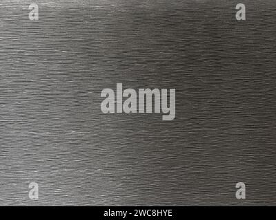 Die Oberfläche dieses schwarzen Hintergrunds ist aufwendig strukturiert und schafft eine fesselnde abstrakte Komposition. Stockfoto