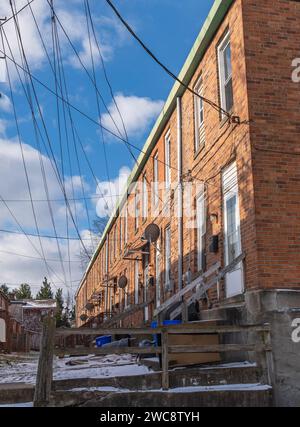 Eine Reihe von Reihenhäusern mit Stromleitungen in Swissvale, Pennsylvania, USA Stockfoto