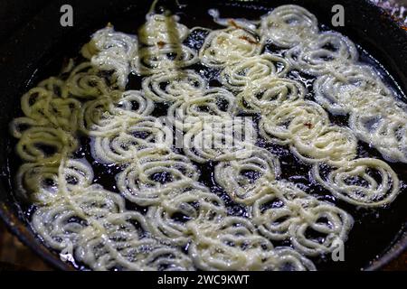 indisches traditionelles süßes Jalebi-Frittieren in heißem raffiniertem Öl Stockfoto