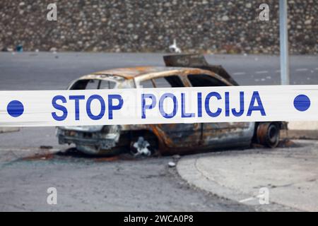 Auto verbrannt von einem Pyromanen mit einem Polizeiband mit der Aufschrift in bosnischer 'POLICIJA STOP'. Stockfoto