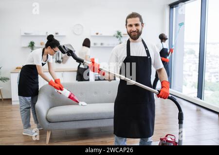 Porträt des Bartreinigers aus dem Reinigungsdienst mit Staubsauger. Stockfoto