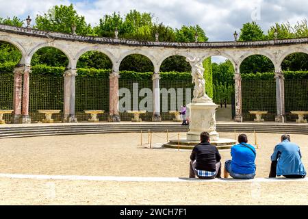 VERSAILLES, FRANKREICH - 12. MAI 2013: Unbekannte Besucher entspannen sich auf der Bosquet Colonnade im Schlosspark. Stockfoto