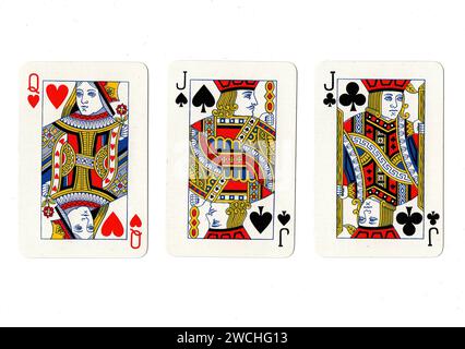 Alte Spielkarten, die ein Paar schwarze Buben und eine rote Königin auf weißem Hintergrund zeigen. Stockfoto