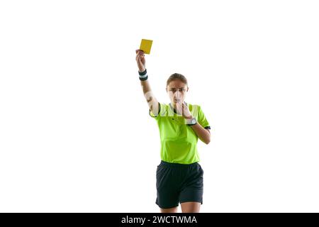 Ernsthafte Frau, Fußball-Schiedsrichter, Hand heben, Spiel stoppen und gelbe Karte als Warnung vor weißem Studiohintergrund zeigen Stockfoto