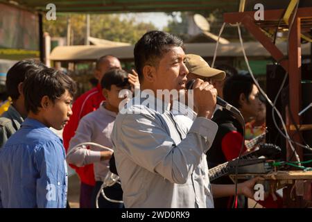 Bagan, Myanmar - 25. Dezember 2019: Ein Burmese singt während der Weihnachtsfeiertage in ein Mikrofon neben Lautsprechern Stockfoto