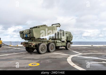 Die US-Marines positionieren ein HIMARS-Fahrzeug auf dem Flugdeck eines Schiffes. Stockfoto