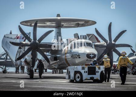 Matrosen nehmen ein E-2C Hawkeye zum Start auf dem Flugdeck der USS Theodore Roosevelt. Stockfoto