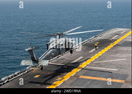 Ein MH-60S Sea Hawk Hubschrauber hebt vom Flugdeck der USS America ab. Stockfoto