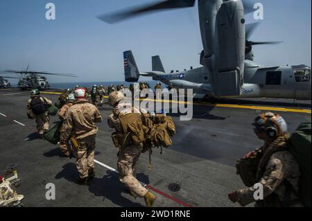 US-Marines gehen an Bord eines MV-22 Osprey an Bord des amphibischen Angriffsschiffs USS America. Stockfoto