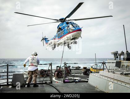 Ein SA-330J Puma Hubschrauber wirft eine Palette Fracht auf dem Flugdeck der USS John S. McCain ab. Stockfoto