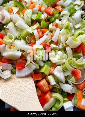 Fein gehacktes Gemüse in einer Pfanne, wenn es zu kochen beginnt. Konzept für gesunde Ernährung. Stockfoto