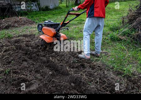 Ein erfahrener Landwirt führt den Kultivierenden durch die fruchtbaren Felder und leitet damit den Grundstein für eine wohlhabende Frühjahrspflanzzeit. Stockfoto