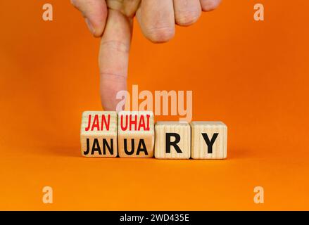 Januhairy oder Januar-Symbol. Konzeptworte Januhairy oder Januar auf schönen Holzblöcken. Schöner oranger Tisch mit orangefarbenem Hintergrund. Mann Hand. Soziale Netzwerke Stockfoto