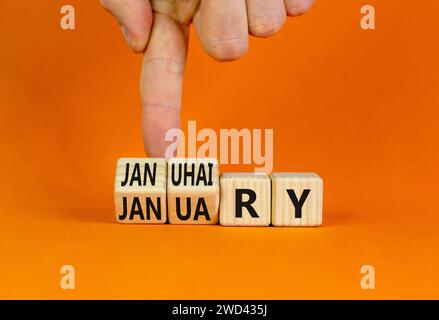 Januhairy oder Januar-Symbol. Konzeptworte Januhairy oder Januar auf schönen Holzblöcken. Schöner oranger Tisch mit orangefarbenem Hintergrund. Mann Hand. Soziale Netzwerke Stockfoto