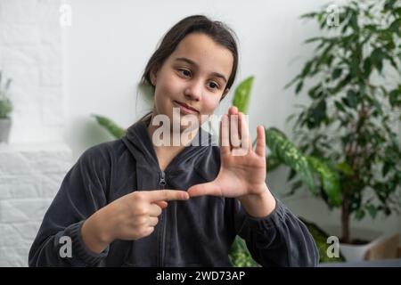 Taubstumme Mädchen mit Gebärdensprache auf hellen Hintergrund Cute Stockfoto