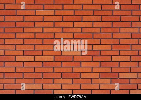 Eine Nahaufnahme einer strukturierten orangen Ziegelwand Stockfoto