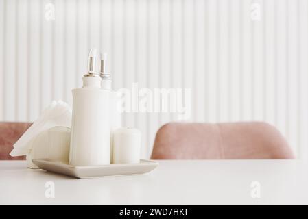 Küchenständer mit Gewürzgläsern auf weißem Holztisch. Salz, Pfeffer, Öl und Essig. Vorderansicht Stockfoto