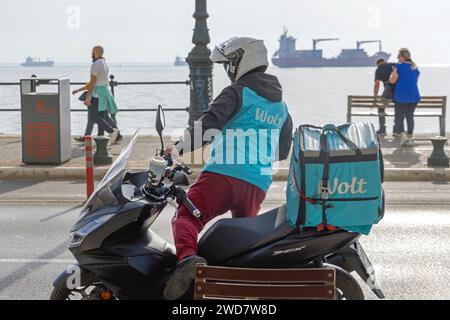 Thessaloniki, Griechenland - 22. Oktober 2023: Lieferung des Fast Food Couriers Wolt Company per Motorrad an der City Street. Stockfoto