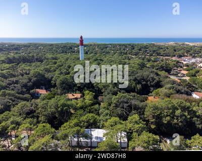 Blick aus der Vogelperspektive auf die Bucht von Arcachon mit vielen Fischerbooten und Austernfarmen, Wald und rotem Leuchtturm Le Phare du Cap Ferret, Halbinsel Cap Ferret, Fra Stockfoto