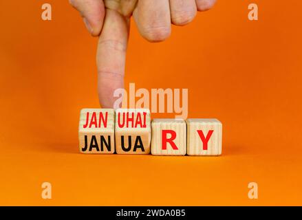 Januhairy oder Januar-Symbol. Konzeptworte Januhairy oder Januar auf schönen Holzblöcken. Schöner oranger Tisch mit orangefarbenem Hintergrund. Mann Hand. Soziale Netzwerke Stockfoto