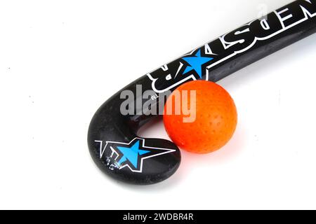 Dublin, Irland - 21. Januar 2024: Ein Foto eines Nedstar Field Hockeyschlägers neben einem orangen Hockeyball auf weißer Oberfläche. Stockfoto