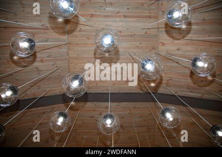 Im Restaurant hängen runde Lampen von der Decke. Im Restaurant sind Lampen an der Decke dekoriert. Feierlichkeiten in einem Restaurant. Originales luxuriöses Dekor Stockfoto