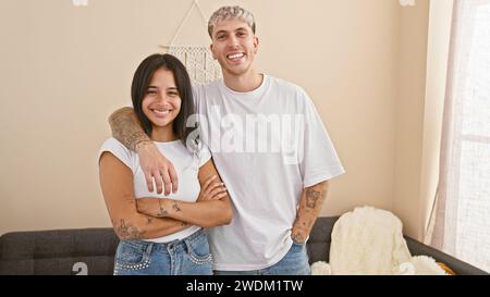 Ein glückliches Paar umarmt sich in ihrem hell beleuchteten Wohnzimmer und strahlt Liebe und Zweisamkeit in einer gemütlichen Atmosphäre aus. Stockfoto