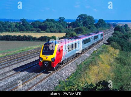 Ein Dieseltriebwagen der Baureihe 220 „Voyager“ mit der Nummer 220028, der am 14. August 2002 in einem Virgin Cross Country-Dienst auf der Manor Farm in der Nähe von Cholsey eingesetzt wurde. Stockfoto