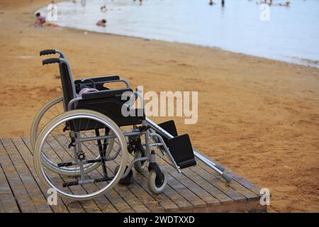 Rollstuhl und Krücken an einem Sandstrand. Hochwertige Fotos Stockfoto