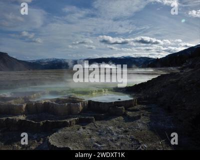 Mammoth Springs mit Bergen Stockfoto