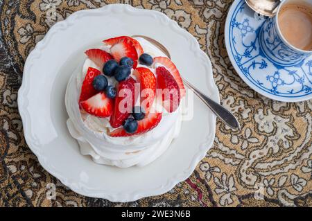 Nachtisch auf Meringue-Basis. Mini Pavlova mit Erdbeere und Heidelbeere. Weichzeichner. Selektiver Fokus. Stockfoto