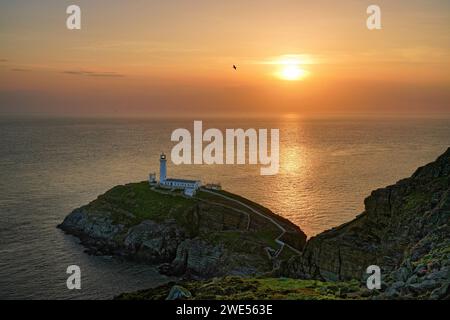 Großbritannien, Nordwestwales, Island of Anglesey, South Stack Lighthouse ist ein Leuchtturm auf der kleinen felsigen Insel South Stack bei Sonnenuntergang Stockfoto