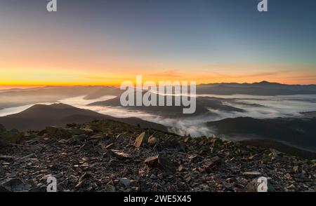 Berglandschaft. Malerische Aussicht auf Bergketten bei Morgennebel bei Sonnenaufgang. Wunderschöne Karpaten. Stockfoto