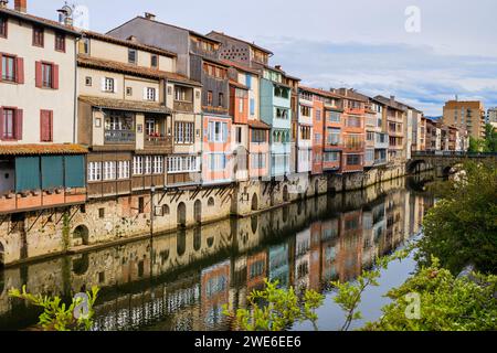 Blick auf die Castres-Architektur auf Häusern entlang des Flusses Agout. Abgewinkelter Blick von der Seite des Flusses mit Blick auf das Haus, das zur alten Brücke führt. Stockfoto