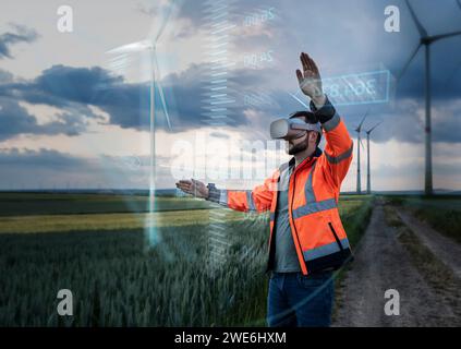 Ingenieur trägt VR-Brille und Programmierung durch das Design digitaler Windkraftanlagen im Außendienst Stockfoto