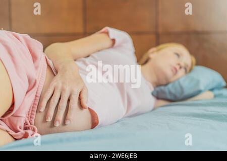 Schlafarme Schwangere leiden unter Schlaflosigkeit und meistern die Herausforderungen der Unruhe während der Schwangerschaft Stockfoto