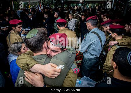 Israelische Soldaten trösten einander während der Beerdigungszeremonie von Major Ilay Levi auf dem Militärfriedhof von Tel Aviv. Major Ilay Levi, 24 Jahre alt, wurde in der Schlacht im südlichen Gazastreifen getötet. 24 israelische Soldaten wurden am Montag in Gaza getötet, die bei weitem größte Zahl israelischer Todesopfer im dreimonatigen Krieg gegen die Hamas an einem Tag, da die Gespräche über einen Waffenstillstand intensiviert wurden und die palästinensischen Opfer weiter stiegen.die Todesopfer kamen während heftiger Kämpfe um die südliche Stadt Khan Younis, mit Dutzenden von Palästinensern, die getötet und verletzt wurden. Die israelischen Opfer dürften die Zahl der Inlandspreise erhöhen Stockfoto