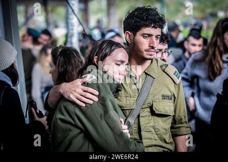 Israelische Soldaten trösten einander während der Beerdigungszeremonie von Major Ilay Levi auf dem Militärfriedhof von Tel Aviv. Major Ilay Levi, 24 Jahre alt, wurde in der Schlacht im südlichen Gazastreifen getötet. 24 israelische Soldaten wurden am Montag in Gaza getötet, die bei weitem größte Zahl israelischer Todesopfer im dreimonatigen Krieg gegen die Hamas an einem Tag, da die Gespräche über einen Waffenstillstand intensiviert wurden und die palästinensischen Opfer weiter stiegen.die Todesopfer kamen während heftiger Kämpfe um die südliche Stadt Khan Younis, mit Dutzenden von Palästinensern, die getötet und verletzt wurden. Die israelischen Opfer dürften die Zahl der Inlandspreise erhöhen Stockfoto