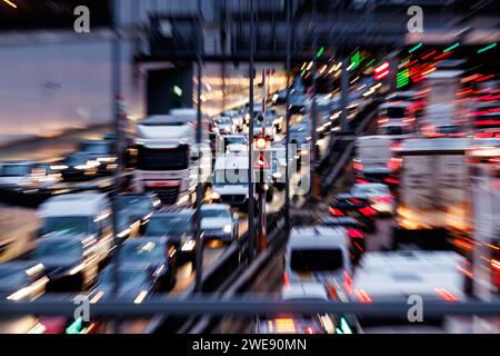 München, Deutschland. Januar 2024. Starker Verkehr auf der zentralen Ringstraße in München während der morgendlichen Hauptverkehrszeit. (Aufnahme mit langsamer Verschlusszeit und Zoom-Effekt) Credit: Matthias Balk/dpa/Alamy Live News Stockfoto