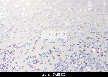 Leuchtendes silbernes Kristallkonfetti auf blauem Hintergrund. Selektiver Fokus. Stockfoto
