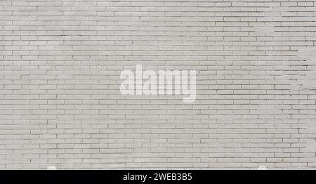 Nahaufnahme einer grauen Ziegelwand. Verlassene Mauer eines Ziegelgebäudes. Stockfoto